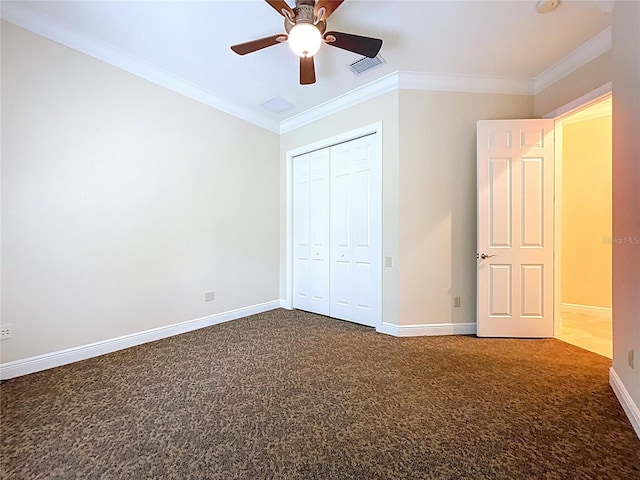 27511 Hialeah Way, Wesley Chapel, FL 33544 - unfurnished bedroom featuring dark carpet, baseboards, crown molding, a closet, and ceiling fan