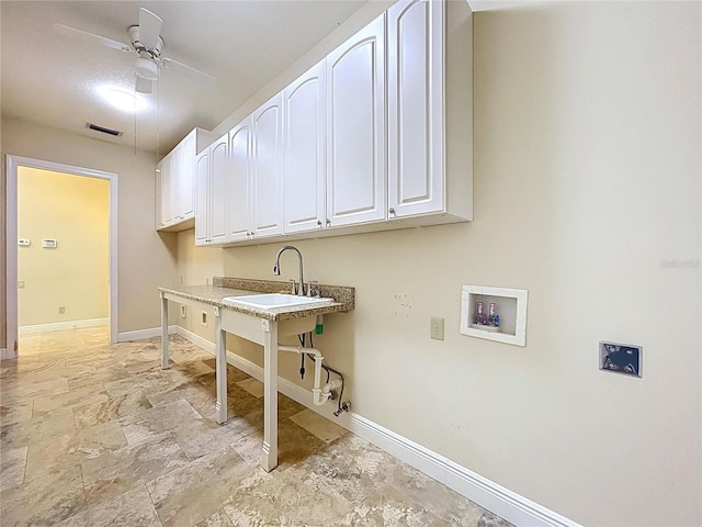 27511 Hialeah Way, Wesley Chapel, FL 33544 - laundry room with hookup for a washing machine, baseboards, a ceiling fan, and light stone finish flooring