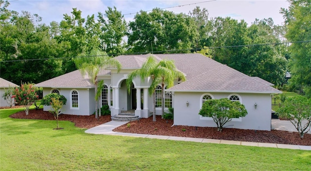 27511 Hialeah Way, Wesley Chapel, FL 33544 - view of front of home with stucco siding, a front yard, and a shingled roof