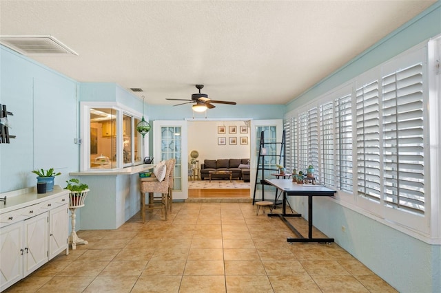 6143 Black Walnut Dr, Bartow, FL 33830 - dining space featuring a ceiling fan, a textured ceiling, and light tile patterned floors
