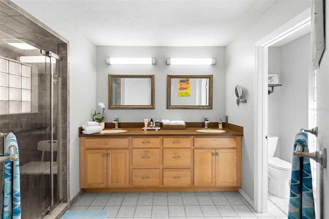 6143 Black Walnut Dr, Bartow, FL 33830 - full bath with toilet, a shower stall, tile patterned flooring, double vanity, and a textured ceiling