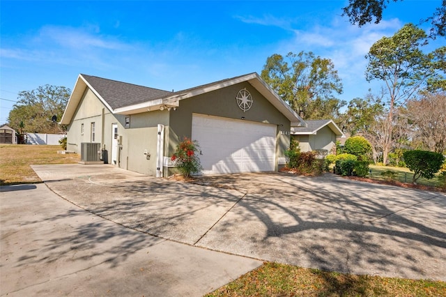 6143 Black Walnut Dr, Bartow, FL 33830 - view of side of home with cooling unit, an attached garage, stucco siding, and concrete driveway