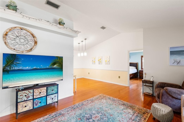 6143 Black Walnut Dr, Bartow, FL 33830 - living room featuring vaulted ceiling, wood finished floors, and baseboards
