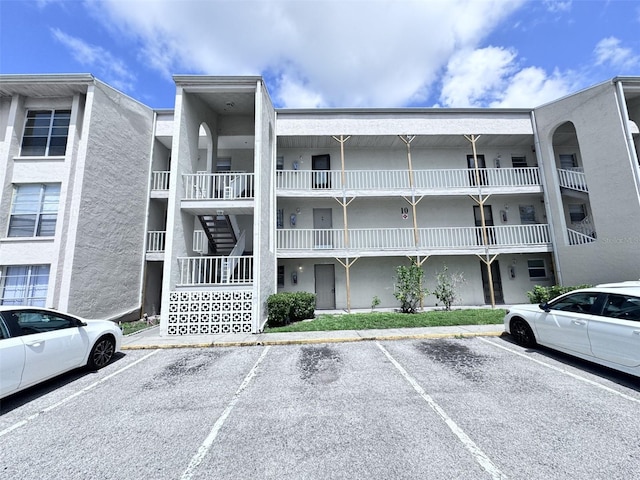 2625 State Road 590 Unit 1012, Clearwater, FL 33759 - view of apartment building / complex featuring uncovered parking and stairs