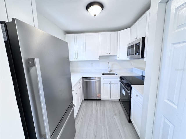2625 State Road 590 Unit 1012, Clearwater, FL 33759 - kitchen with stainless steel appliances, a sink, and white cabinetry
