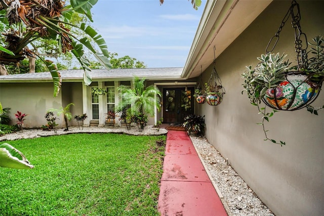 1151 Lancer Ln, Tarpon Springs, FL 34689 - doorway to property with stucco siding and a yard