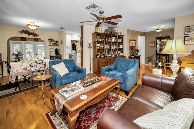 1151 Lancer Ln, Tarpon Springs, FL 34689 - living area with a ceiling fan, light wood finished floors, and arched walkways