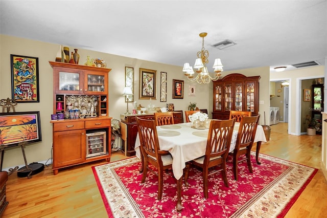 1151 Lancer Ln, Tarpon Springs, FL 34689 - dining room with a chandelier and light wood finished floors