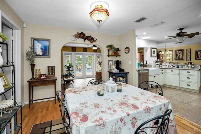 1151 Lancer Ln, Tarpon Springs, FL 34689 - dining area with arched walkways, a ceiling fan, light wood-style flooring, recessed lighting, and french doors