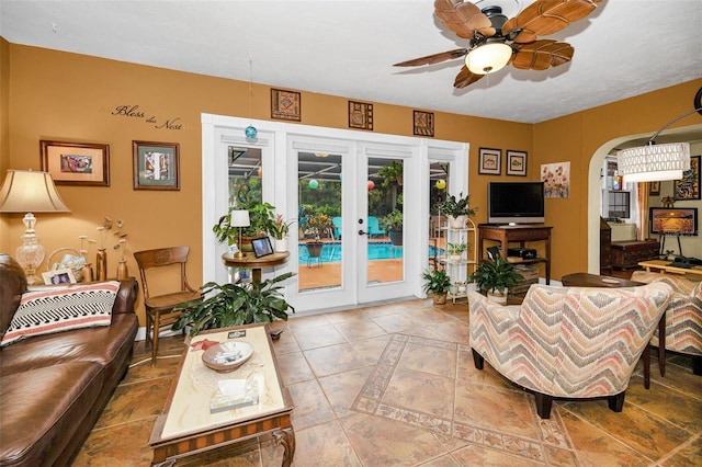1151 Lancer Ln, Tarpon Springs, FL 34689 - living area featuring ceiling fan, french doors, arched walkways, and tile patterned flooring