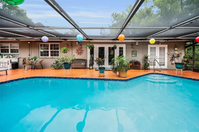 1151 Lancer Ln, Tarpon Springs, FL 34689 - swimming pool with french doors, glass enclosure, and a patio area