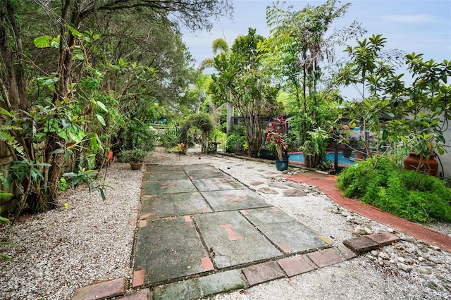 1151 Lancer Ln, Tarpon Springs, FL 34689 - fenced backyard featuring a patio