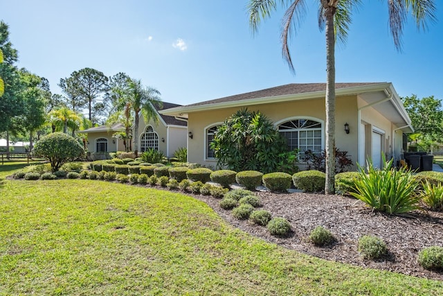 3452 Forelock Rd, Tarpon Springs, FL 34688 - view of front facade with stucco siding, a front lawn, and an attached garage