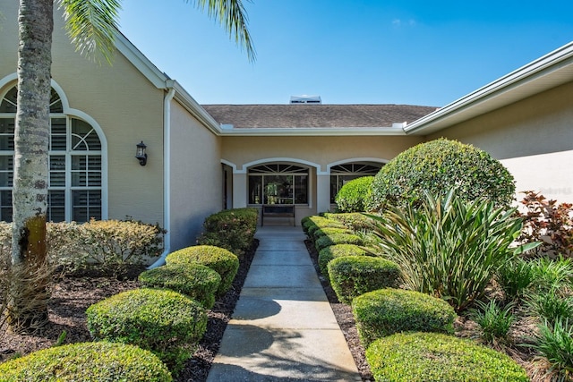 3452 Forelock Rd, Tarpon Springs, FL 34688 - entrance to property featuring stucco siding and a shingled roof