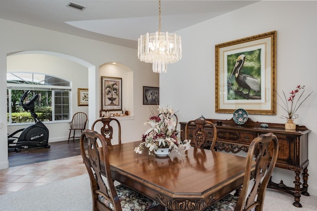 3452 Forelock Rd, Tarpon Springs, FL 34688 - tiled dining area featuring a chandelier and arched walkways