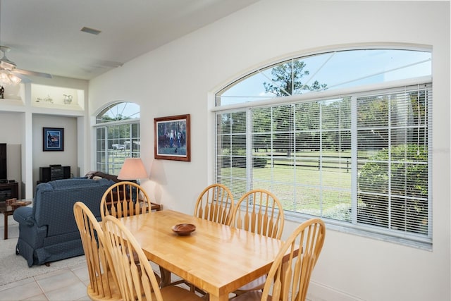 3452 Forelock Rd, Tarpon Springs, FL 34688 - dining area with a ceiling fan, light tile patterned flooring, and a wood stove