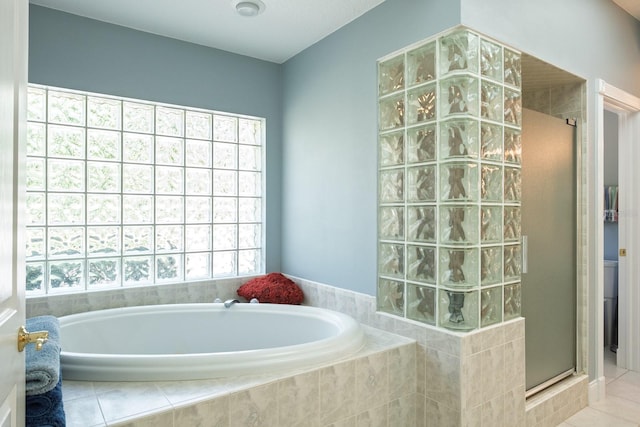 3452 Forelock Rd, Tarpon Springs, FL 34688 - bathroom with a stall shower, a bath, and tile patterned flooring