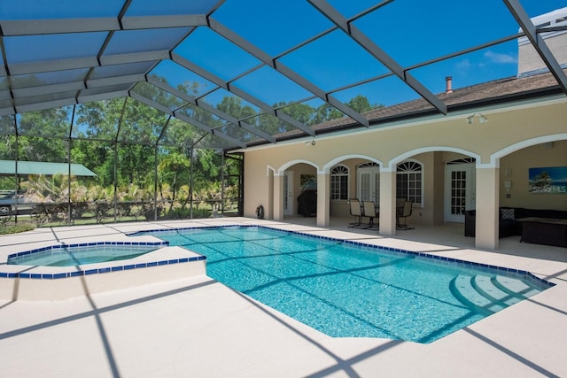3452 Forelock Rd, Tarpon Springs, FL 34688 - view of swimming pool featuring a patio, glass enclosure, and a pool with connected hot tub