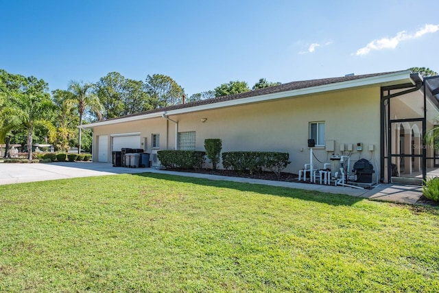 3452 Forelock Rd, Tarpon Springs, FL 34688 - view of front of property featuring stucco siding, driveway, a front yard, and a garage