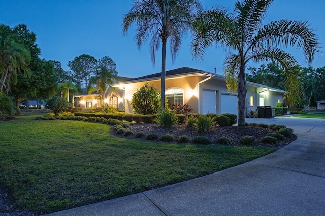 3452 Forelock Rd, Tarpon Springs, FL 34688 - view of side of property featuring stucco siding, a yard, an attached garage, and driveway