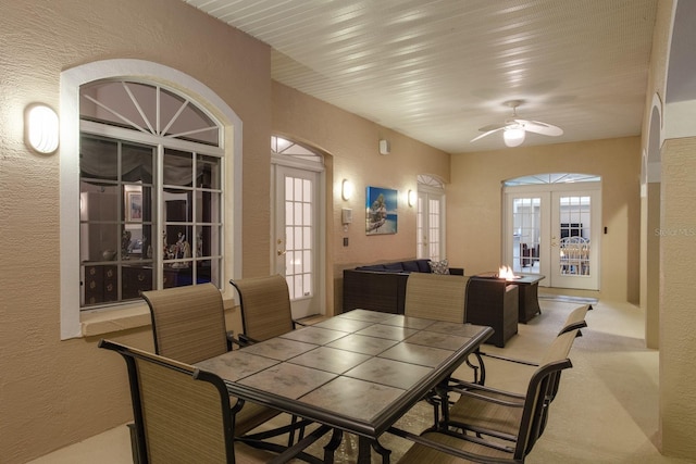 3452 Forelock Rd, Tarpon Springs, FL 34688 - dining space featuring a textured wall, a ceiling fan, and french doors