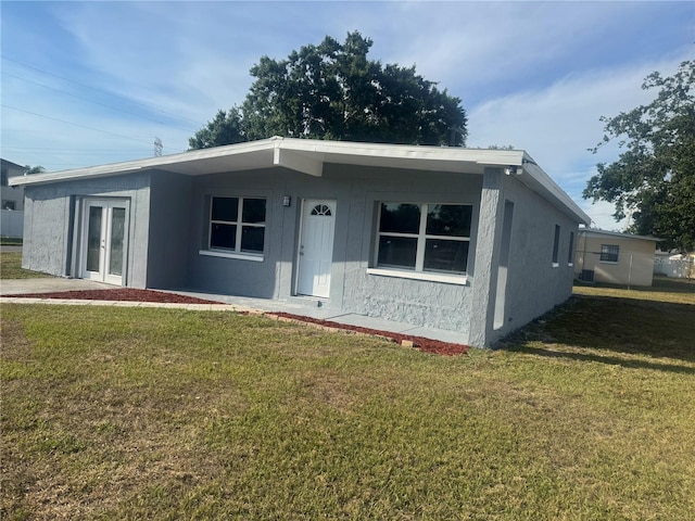 8502 Grapefruit Ave, Tampa, FL 33619 - view of front of home featuring a front yard and french doors