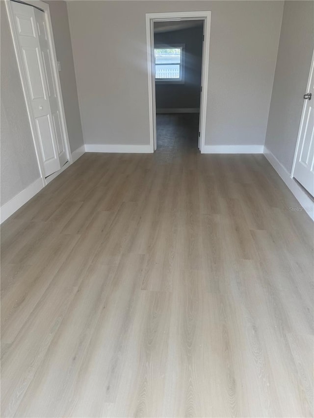 8502 Grapefruit Ave, Tampa, FL 33619 - unfurnished bedroom featuring wood finished floors and baseboards