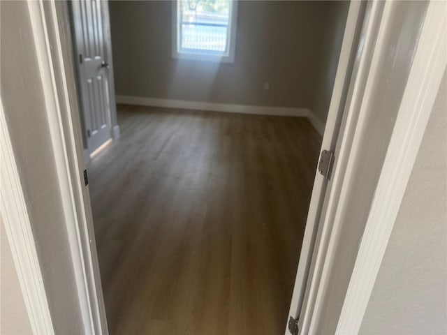 8502 Grapefruit Ave, Tampa, FL 33619 - empty room featuring wood finished floors and baseboards