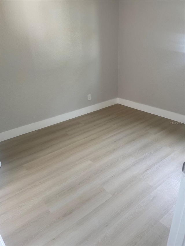 8502 Grapefruit Ave, Tampa, FL 33619 - empty room featuring baseboards and wood finished floors