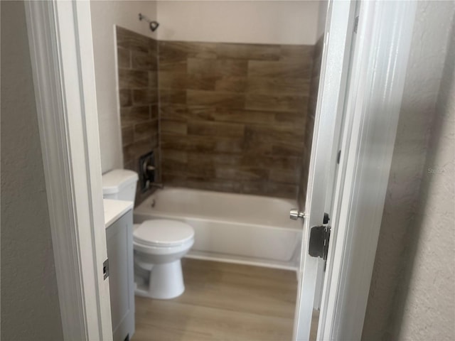 8502 Grapefruit Ave, Tampa, FL 33619 - bathroom with wood finished floors, vanity, bathtub / shower combination, and toilet