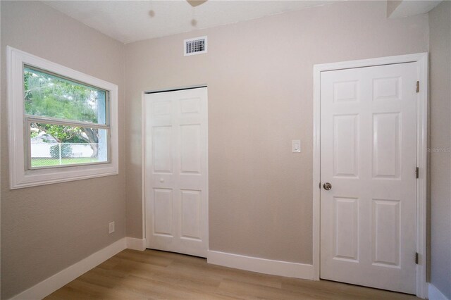 8502 Grapefruit Ave, Tampa, FL 33619 - unfurnished bedroom featuring light wood-style flooring and a closet