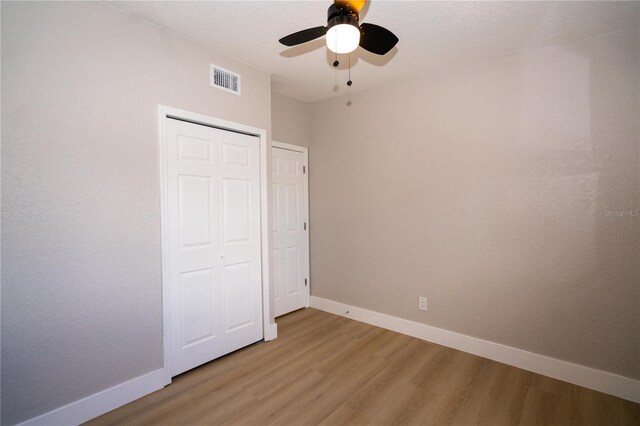 8502 Grapefruit Ave, Tampa, FL 33619 - unfurnished bedroom featuring light wood-style flooring, a closet, and ceiling fan