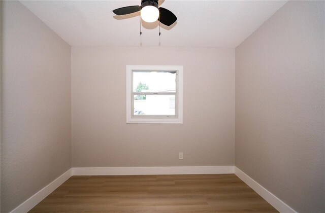 8502 Grapefruit Ave, Tampa, FL 33619 - empty room with ceiling fan and wood finished floors