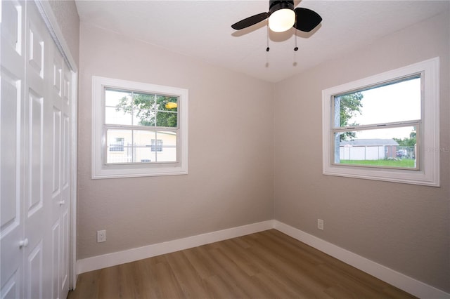 8502 Grapefruit Ave, Tampa, FL 33619 - unfurnished bedroom with a closet, wood finished floors, and ceiling fan
