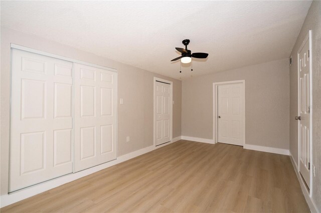 8502 Grapefruit Ave, Tampa, FL 33619 - unfurnished bedroom featuring light wood-style floors and a ceiling fan