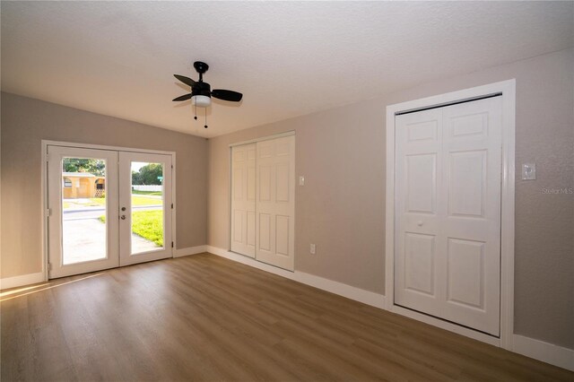 8502 Grapefruit Ave, Tampa, FL 33619 - unfurnished bedroom with access to outside, french doors, wood finished floors, and two closets