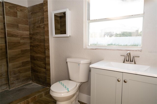 8502 Grapefruit Ave, Tampa, FL 33619 - full bathroom with vanity, a tile shower, and a textured wall