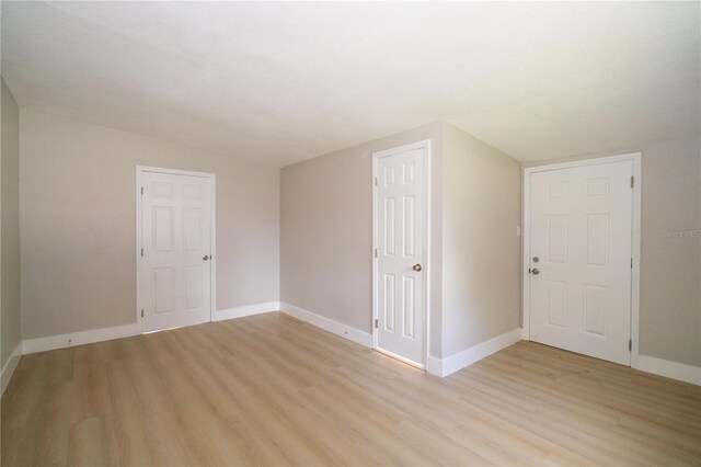 8502 Grapefruit Ave, Tampa, FL 33619 - additional living space with light wood-type flooring and vaulted ceiling