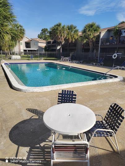 6306 Newtown Cir Unit 6A3, Tampa, FL 33615 - community pool featuring a patio area