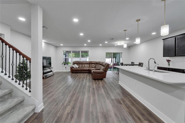 6658 Devlin Ln, Wesley Chapel, FL 33545 - living room with dark wood-style floors, baseboards, recessed lighting, and stairs