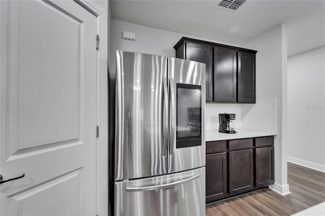 6658 Devlin Ln, Wesley Chapel, FL 33545 - kitchen featuring smart refrigerator, light wood-style floors, light countertops, baseboards, and dark brown cabinetry