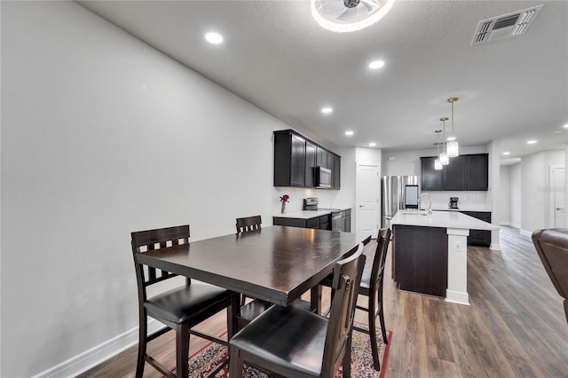 6658 Devlin Ln, Wesley Chapel, FL 33545 - dining room with dark wood-style flooring, recessed lighting, and baseboards