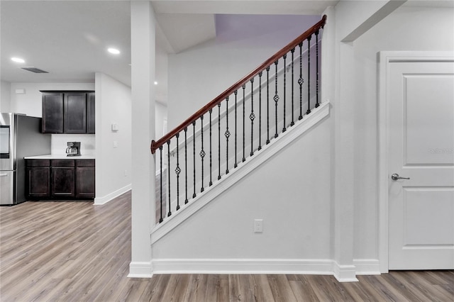 6658 Devlin Ln, Wesley Chapel, FL 33545 - stairway featuring wood finished floors, baseboards, and recessed lighting