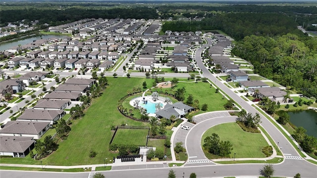 6658 Devlin Ln, Wesley Chapel, FL 33545 - aerial overview of property's location featuring nearby suburban area, a pool area, a large body of water, and a heavily wooded area