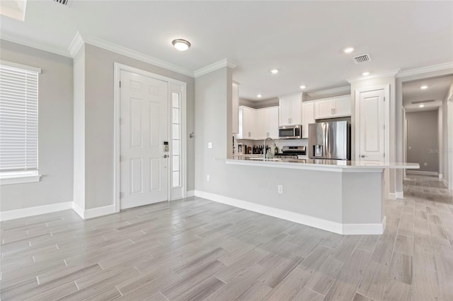 16126 San Donato Pl, Bradenton, FL 34211 - kitchen with appliances with stainless steel finishes, light wood-style floors, light countertops, crown molding, and recessed lighting