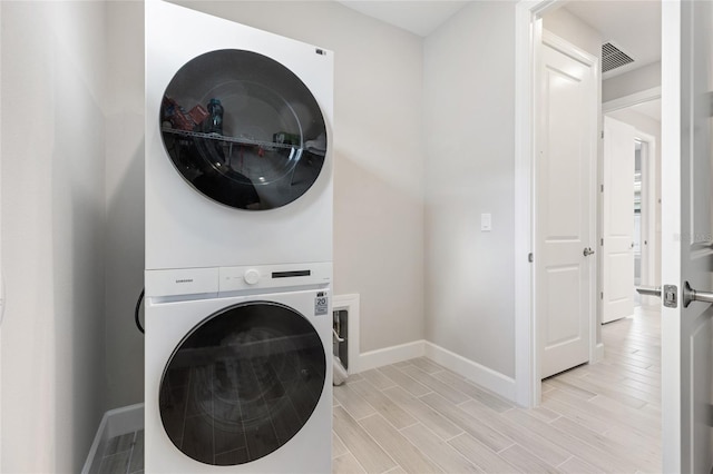 16126 San Donato Pl, Bradenton, FL 34211 - washroom featuring stacked washer / dryer and wood finish floors