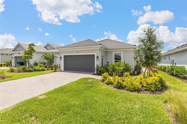 16126 San Donato Pl, Bradenton, FL 34211 - ranch-style home featuring a garage, a front lawn, decorative driveway, stucco siding, and a tiled roof