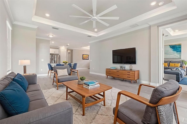 16126 San Donato Pl, Bradenton, FL 34211 - living area with a tray ceiling, ornamental molding, a ceiling fan, light wood-style floors, and recessed lighting