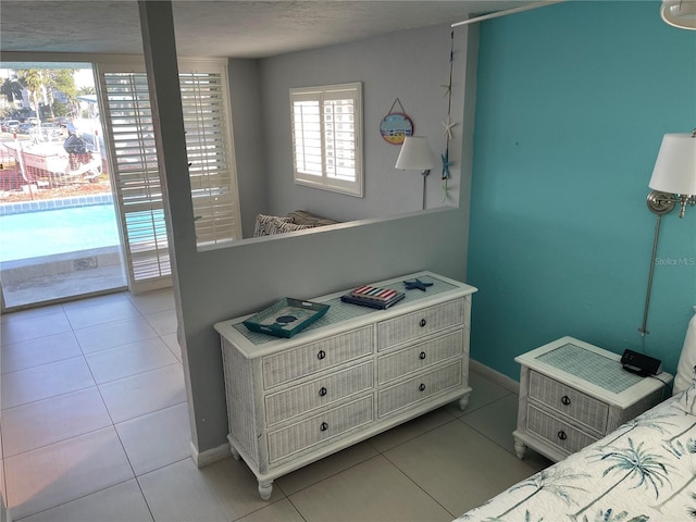 800 Bayway Blvd Unit 14, Clearwater Beach, FL 33767 - bedroom with baseboards and tile patterned floors