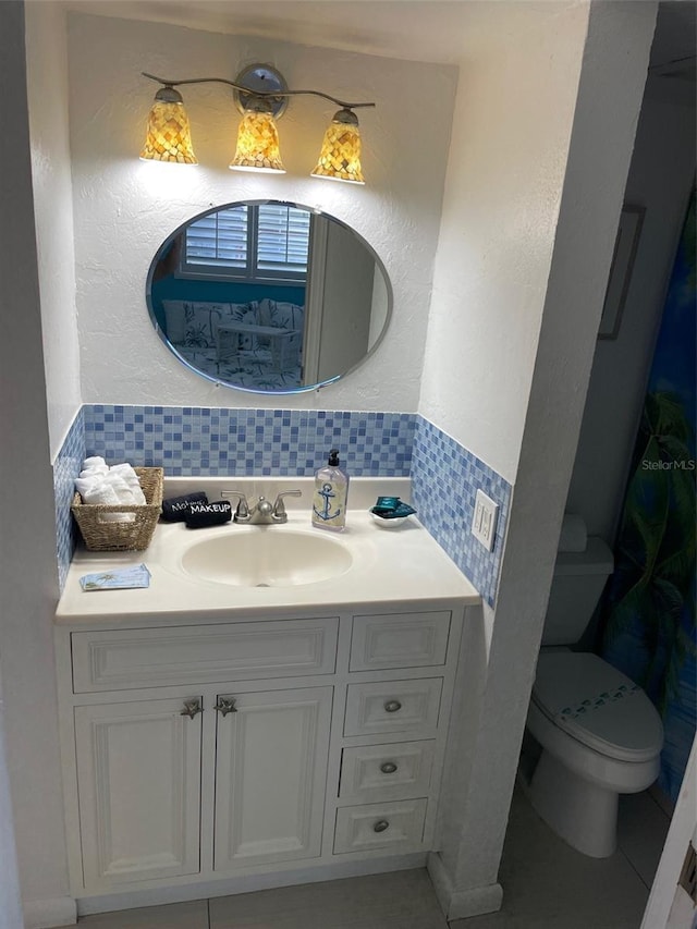 800 Bayway Blvd Unit 14, Clearwater Beach, FL 33767 - bathroom featuring vanity, backsplash, and a textured wall
